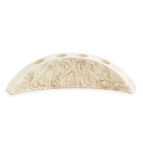 Curved cream colored ceramic candle holder with four openings for advent candles. On the front of the holder is a carved depiction of the nativity story.
