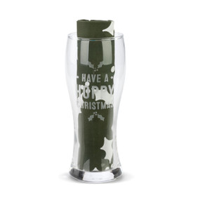 A clear pilsner glass that says "Have A Hoppy Christmas" with a dark green towel rolled and standing in the glass.