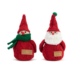 Two small gnome figures in red sweaters and knit red hats. One has a green scarf and the other a white beard. They each have a tag on their sweater that says "Stay Warm Stay Cozy" and "Comfort & Joy" respectively.