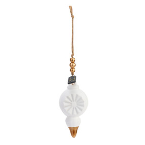 A white finial shaped ornament with gold beads at the top and a rim of gold at the bottom. The ornament is a diffuser.