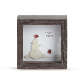 A square dark wood shadow box with a snowman and red birds and says "make it merry" made from glass pebbles.