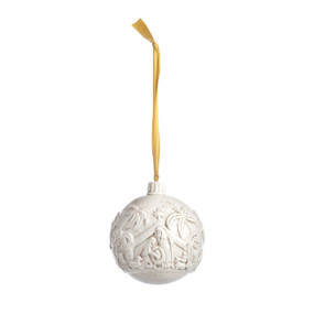 An off-white round hanging ornament depicting the nativity scene, which goes all the way around the ornament.