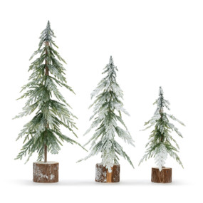 Three fake snow frosted trees in varying heights situated in wood stump bases, displayed in a line from tallest to shortest.