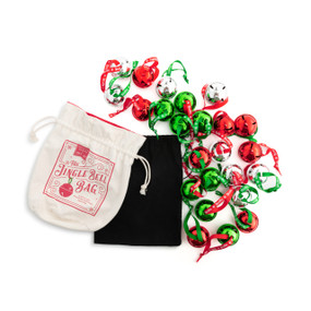 A set of red, green and silver jingle bells with ribbons attached next to a black interior bag and an outer white drawstring bag that says "The Jingle Bell Bag".