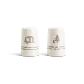 A set of white ceramic salt and pepper shakers. One has a camper van and the other has a pine tree and rabbit.