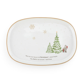 A white oval platter with Pooh and Piglet looking up at a Christmas tree with the saying "How do you know it's Christmas?" asked Piglet. "You feel it all around," said Pooh.