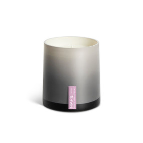 A Rosé + Vanilla Orchid poured tester candle in an ombre gray glass vessel.