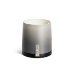A White Oak + Cashmere poured tester candle in an ombre gray glass vessel.