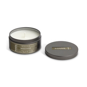 A round dark metal travel tin with a white candle, displayed with the lid off to the side. The candle has a Smoked Woods scent.