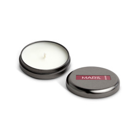 A small round dark metal tin with a white candle displayed with the lid off to the side. The candle has a Rose + Leather scent.
