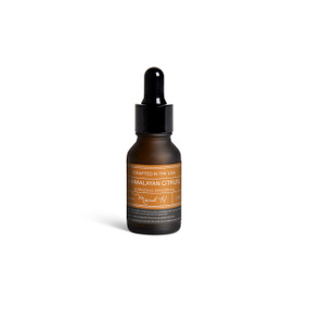 A small dark bottle of Himalayan Citrus diffuser oil with a black dropper lid.