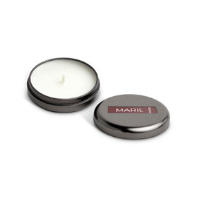 A small round dark metal tin with a white candle displayed with the lid off to the side. The candle has a Tobacco + Saffron scent.