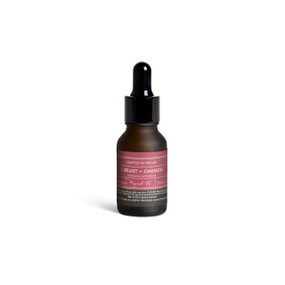 A small dark bottle of Currant + Oakmoss diffuser oil with a black dropper lid.