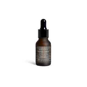A small dark bottle of Pumpkin + Birch diffuser oil with a black dropper lid.
