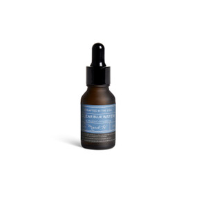 A small dark bottle of Clear Blue Water diffuser oil with a black dropper lid.