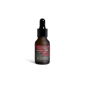 A small dark bottle of Cinnamon + Cedar diffuser oil with a black dropper lid.