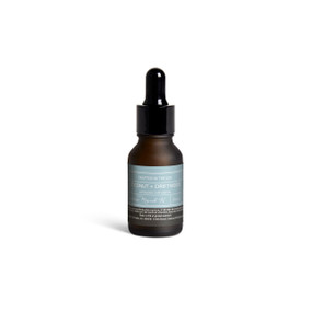 A small dark bottle of Coconut + Driftwood diffuser oil with a black dropper lid.