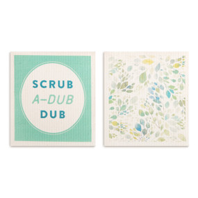 Two light green biodegradable dish cloths, one with a blue and green leaf pattern and one that says "Scrub A-Dub Dub".