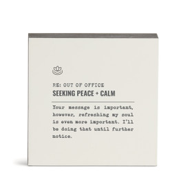 A white square wall art with the saying "RE: Out of Office Seeking Peace + Calm" with a short write up about someone seeking calm.