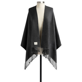A black fringed wrap displayed on a mannequin.