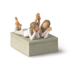 Front/long side view of closed rectangular blue-gray resin box, box; sculpture of two reclining girls on box lid