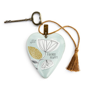 A heart shaped light green sculpture with an illustrated modern flower with a gold tassel and metal key attached. The heart has the saying "Friends Always".