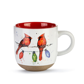 White ceramic mug with a textured base and red interior. The mug has a watercolor image of two cardinals on a holiday light string.