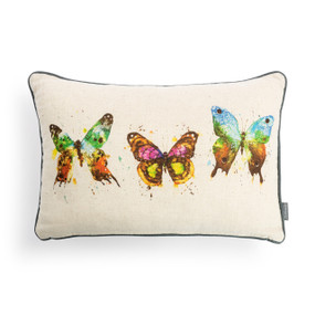 A rectangular cream pillow with the watercolor image of three colorful butterflies.