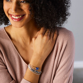 A multistrand bracelet with silver chain and beads in shades of blue and white.