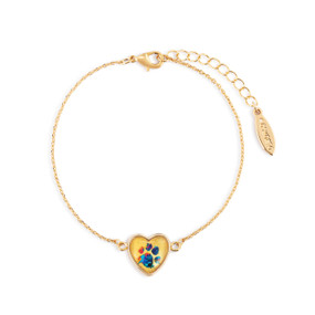 An adjustable gold chain bracelet with a heart shaped charm with colorful paw print inside.