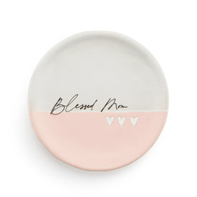 A small round light pink and white ceramic trinket dish with the saying "Blessed Mom" in the middle.