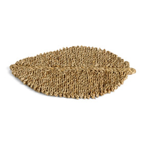 A woven rattan brown mat in the shape of a leaf.