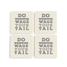 A set of four white ceramic coasters with the saying "Do Whatever Wags Your Tail".