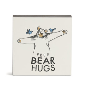 A white square wall art with an illustration of a bear about to give a hug and the saying "Free bear hugs".