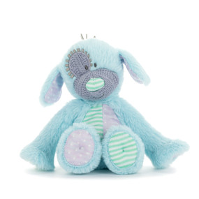 A mini light blue plush puppy with a knit purple nose and eye patch. The puppy has purple and green ears, tummy and paws.