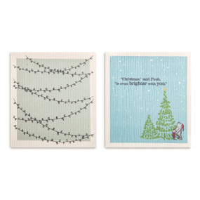 Two blue and gray biodegradable dish cloths. One is gray with strings of lights and the other is blue and says "Christmas, said Pooh, is even brighter with you" and has an image of Pooh and Piglet.