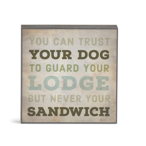 A small square brown wall art with the saying "You can trust your dog to guard your lodge but never your sandwich".