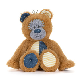 A mini brown plush bear with knit purple nose and eyes. The bear has yellow and blue ears, tummy and paws.