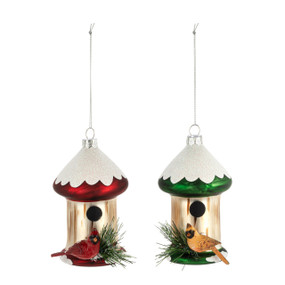 Two snowy birdfeeder ornaments, one red and the other green. There is a male cardinal on the red one and a female cardinal on the green one.