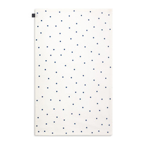 A white kitchen towel with blue polka dots displayed with the towel laid out flat.