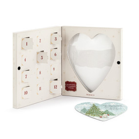 A heart shaped Winnie-the-Pooh holiday puzzle where the pieces are inside 12 countdown holes in a white box.