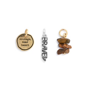 A set of three different gold and silver charms about bravery.