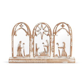 A three panel arched wood cutout of the nativity scene in whitewashed wood.