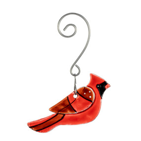 A glass ornament of a red cardinal bird with a curved silver hanger.