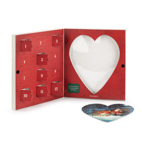 A heart shaped Santa and sleigh themed puzzle where the pieces are inside 12 countdown holes in a red box.