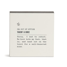 A white square wall art with the saying "RE: Out of Office Takin' A Hike" with a short write up about someone out hiking.