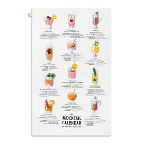 A white kitchen towel with illustrations and directions for monthly mocktails, displayed laid out flat.