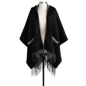 A black and gray wrap with a hood, pockets and fringe on the ends displayed on a mannequin.