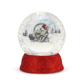 A lit snow globe with a red glittery base and an image of Pooh and Piglet sitting on a log among the snow inside.