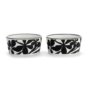 Two white ceramic ramekins with a black and white floral pattern on the outside, displayed angled to show the inside rim allowing them to stack.